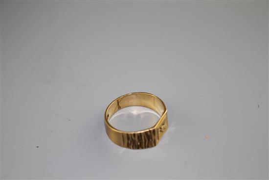 A modern 9ct gold and diamond chip set signet ring, with textured shoulders, size R/S, gross 3.9 grams.